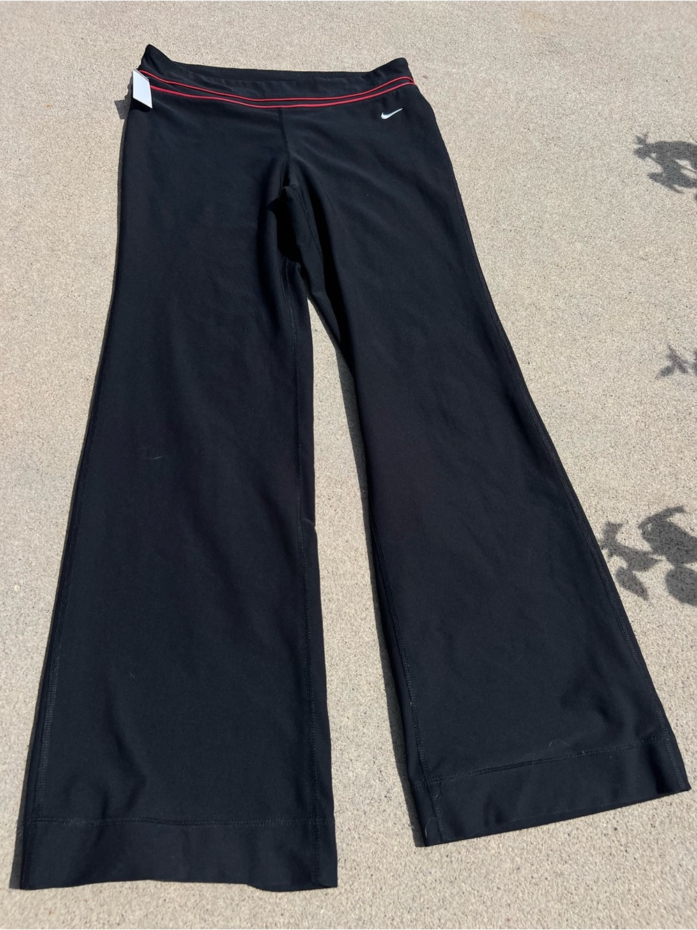 Nike women’s Black Flare Yoga Pants with Red Waistband Detail